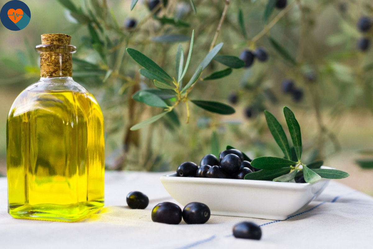 a bowl of olive and a bottle of oil